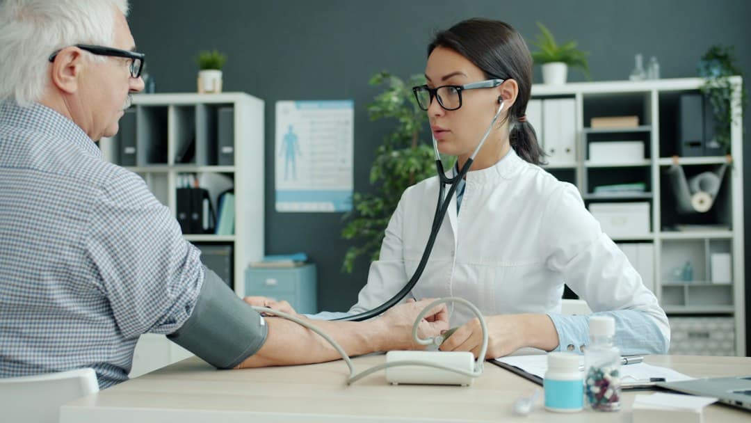 Provider checking a patient's blood pressure before choosing tirzepatide vs semaglutide