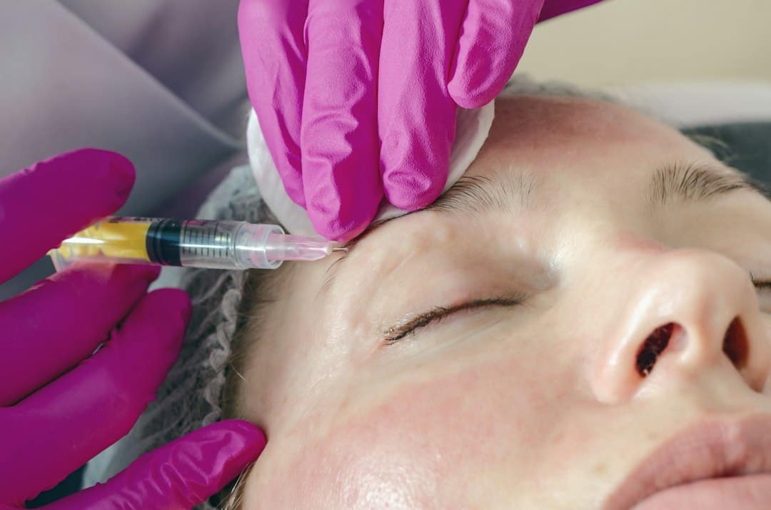 Woman receiving anti-wrinkle injections near the eyes, comparing Botox vs Xeomin
