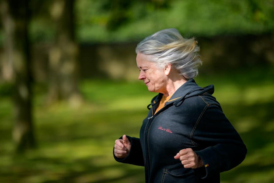 Woman jogging outdoors, staying active while using GLP-1 for menopause weight gain