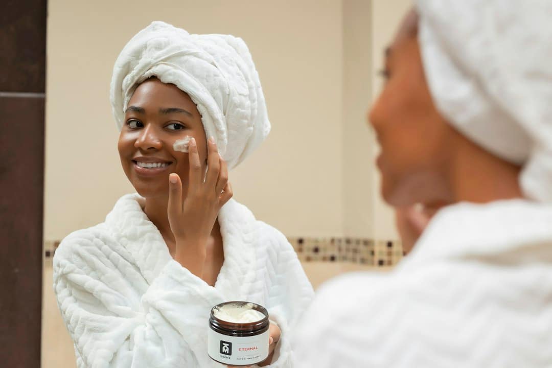 Woman applying face cream, part of a skincare routine for what reduces wrinkles